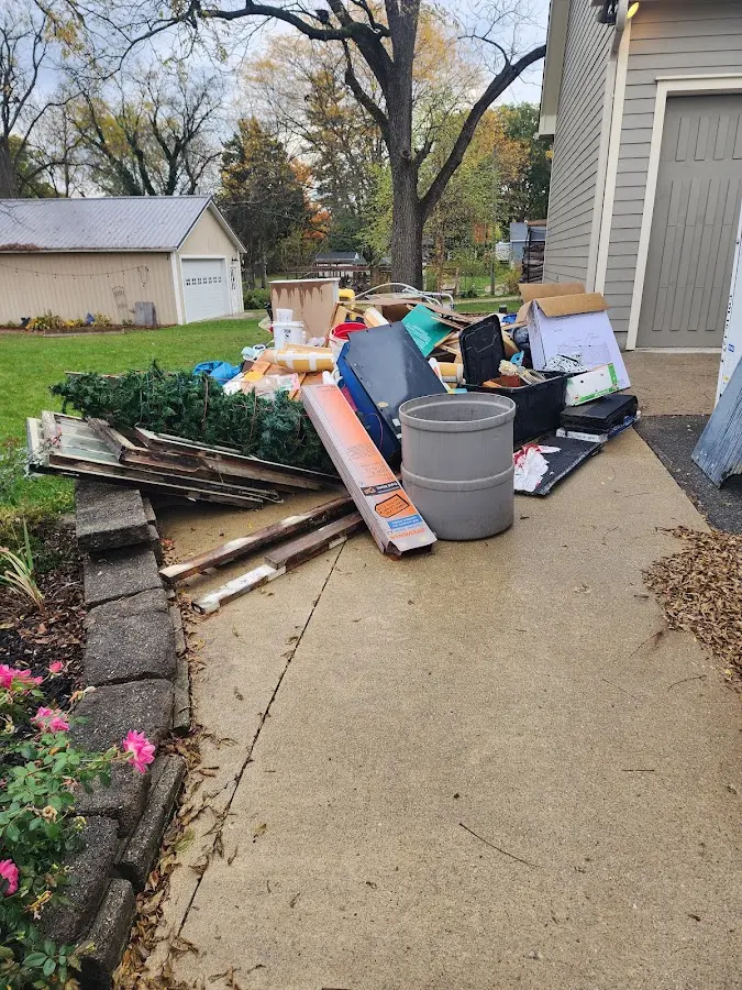 Dumpster being loaded with debris for Estate Cleanout Dumpster Rental in Affton